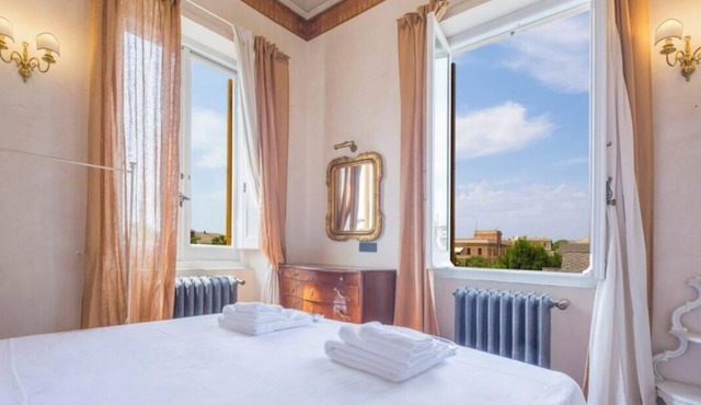 The Cinque Terre Suite, located on the first floor of La Dolce Vita at Villa Aranci in Via Fabio Filzi 2B, Genoa, is a vibrant and colorful double room with a private bathroom.Guests enjoy access to the panoramic kitchen with stained-glass windows, the b